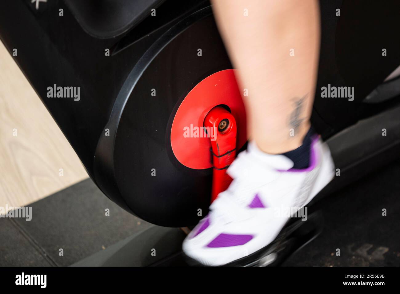 Indoor bicycle spinning interior cycling with an indoor trainer with fast moving legs Stock Photo