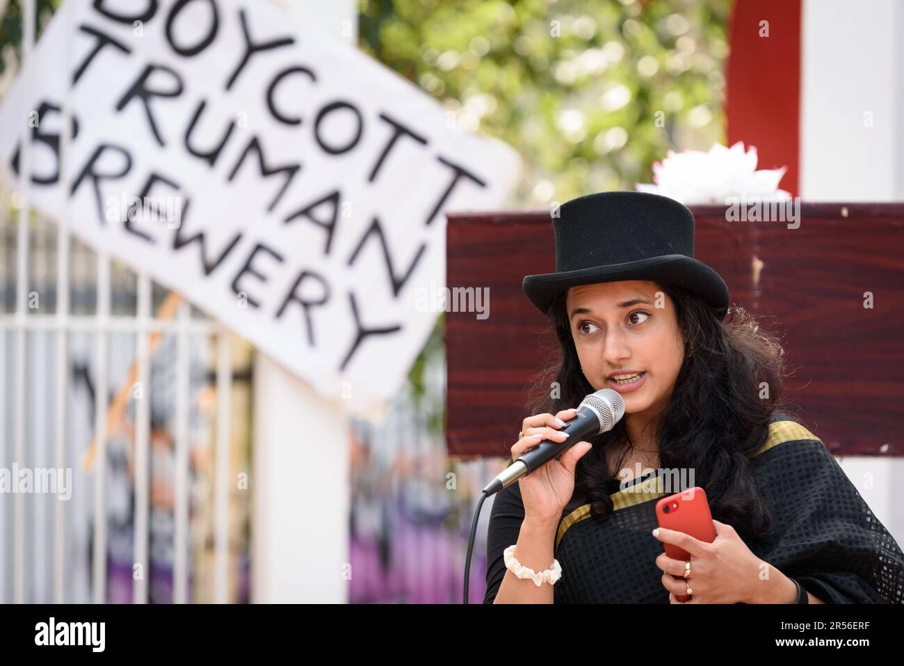 A community activist addresses a rally in Altab Ali Park against plans to build shops and offices on the Truman Brewery site in Brick Lane, London. Stock Photo