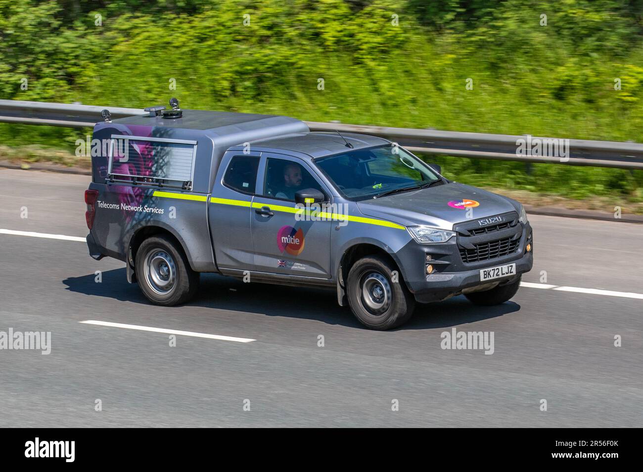 MITIE Telecoms Network Services 2022 yellow striped Isuzu D-Max Utility TD 164 4WD Start/Stop Silver LCV Pick Up Diesel 1898 cc Euro Status 6dar travelling on the M61 motorway, UK Stock Photo