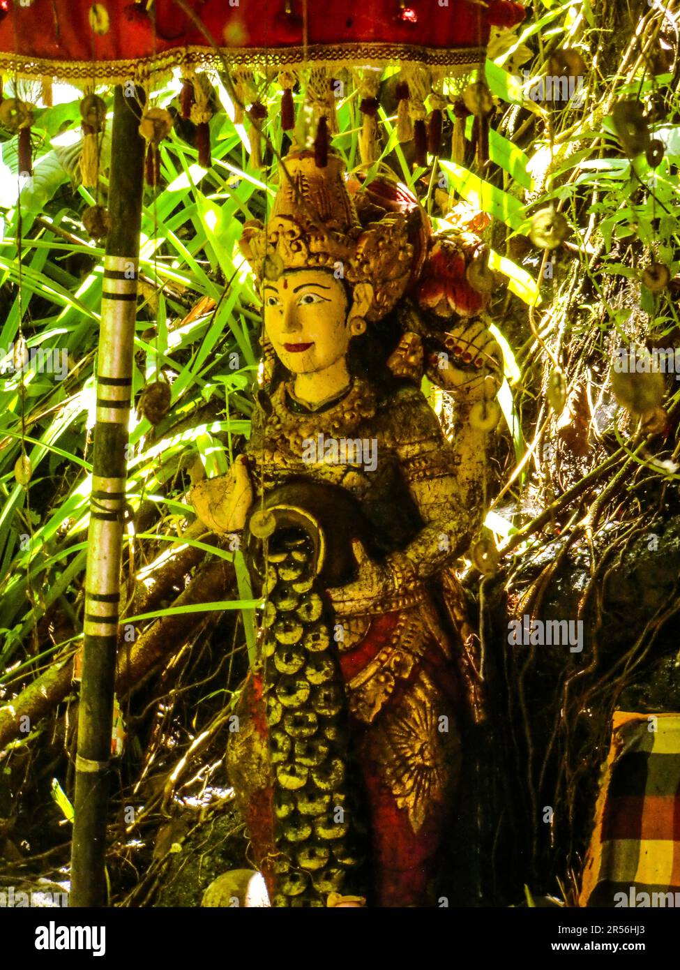 Balinese God statue in temple complex Taman Beji Griya Waterfall