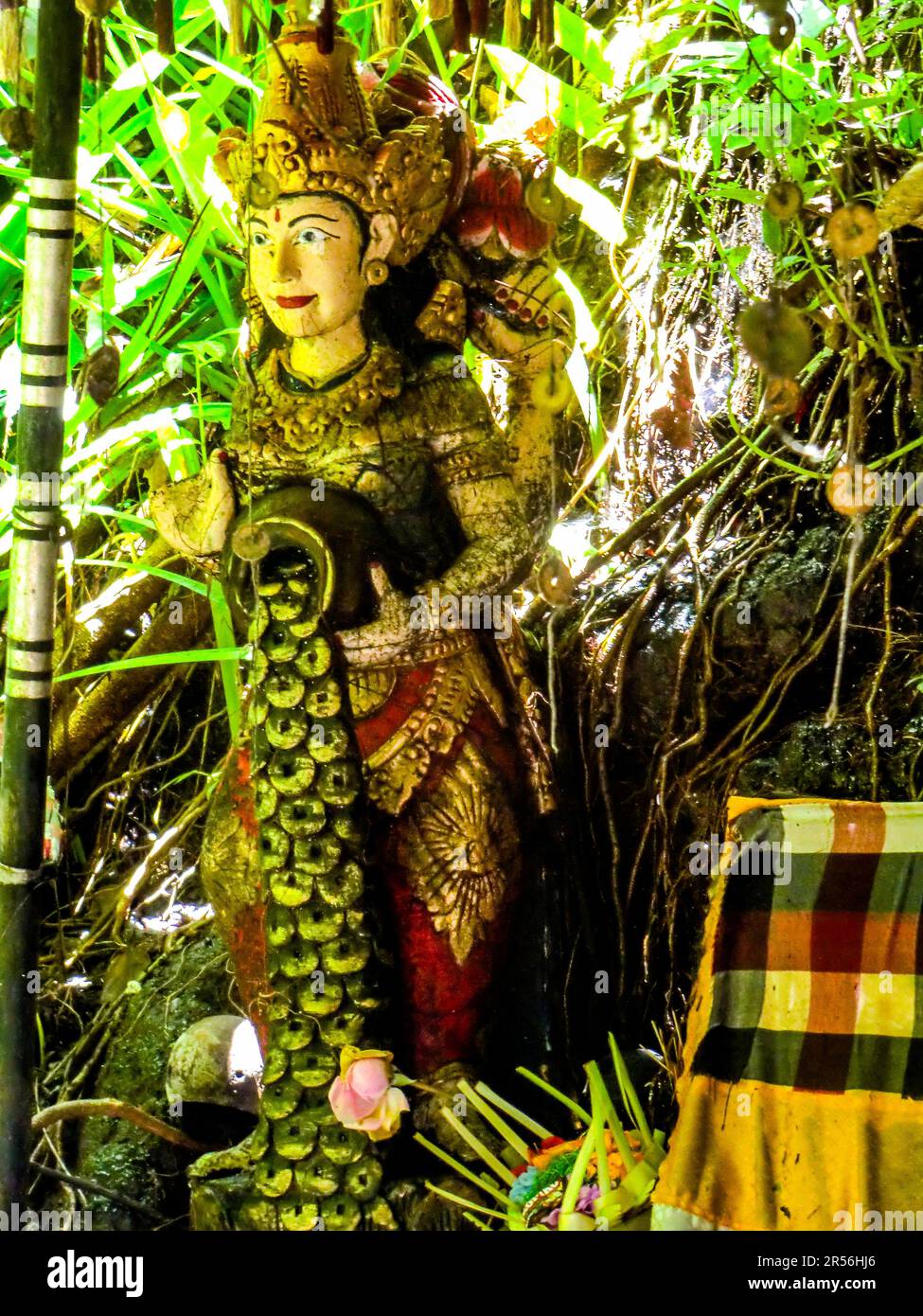 Balinese God statue in temple complex Taman Beji Griya Waterfall
