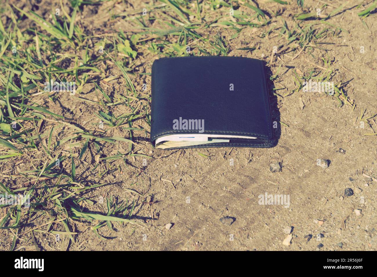 black leather wallet lying on the ground Stock Photo