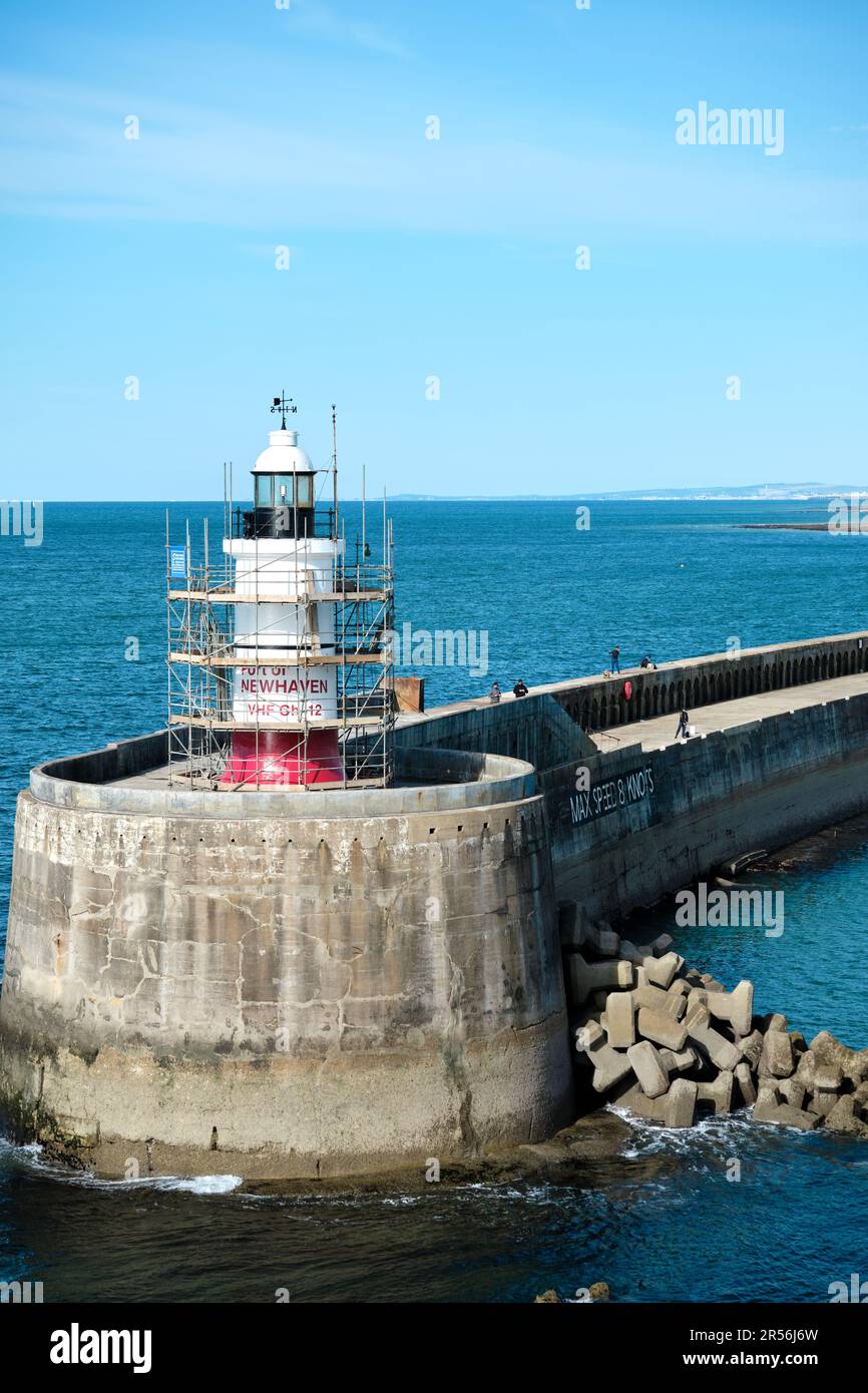Newhaven, East Sussex, United Kingdom - September 18th 2022: Scaffolding around the lighthouse for repainting. Sunny with clear blue sky and water. Stock Photo