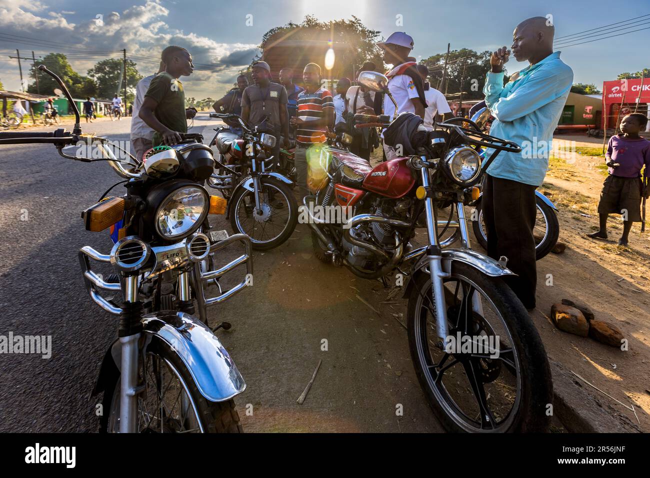 Motorcycles are a common means of transportation in Malawi. Before the ride, the price is negotiated between the driver and passenger Stock Photo