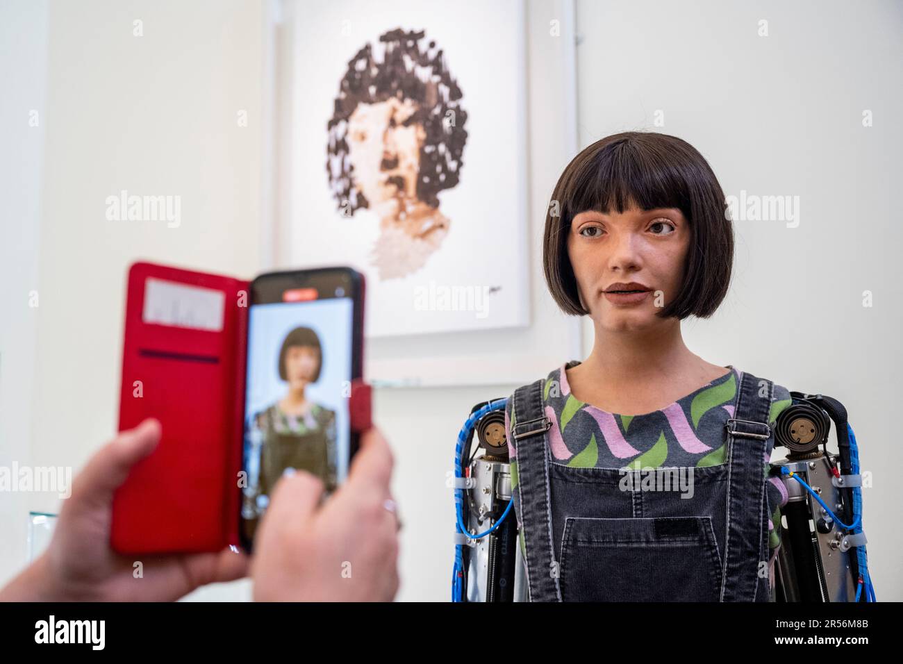 London, UK.  1 June 2023. A visitor interacts with Ai-Da robot, the world’s first humanoid robot artist, on the opening day of London Design Biennale 2023 at Somerset House. Using artificial intelligence (AI), she will be designing objects during the festival.  Over 40 international design exhibitors are presenting installations showcasing designs that confront global challenges across a variety of mediums.  The show runs 1 to 25 June.  Credit: Stephen Chung / Alamy Live News Stock Photo