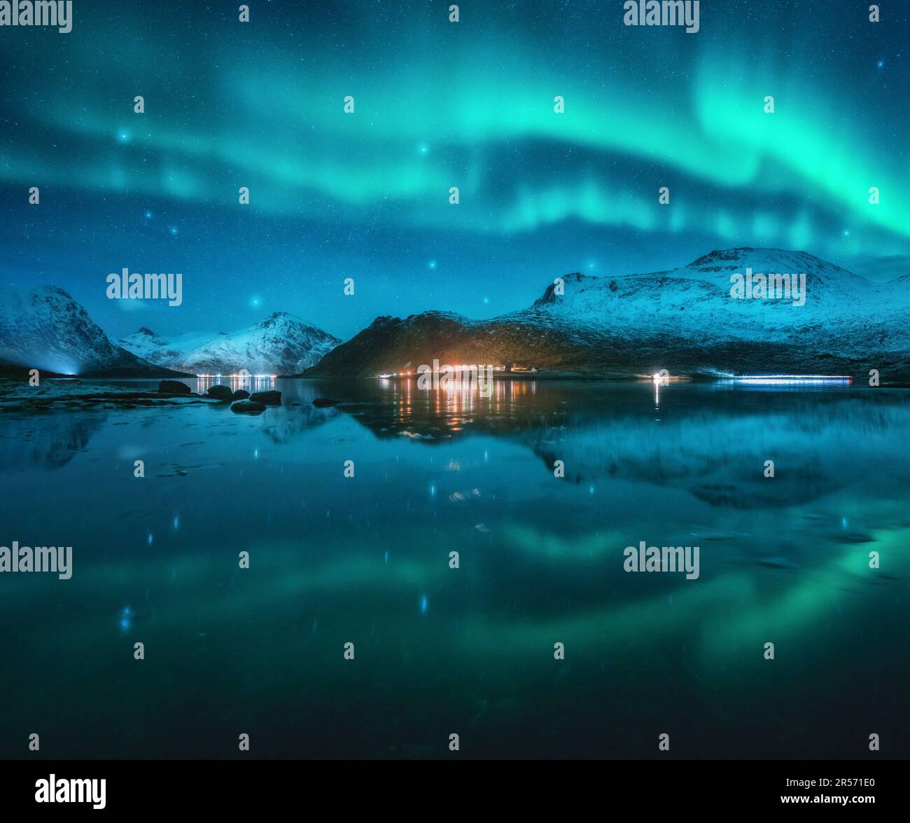 Northern lights over the snowy mountains, sea, fjord, reflection Stock ...