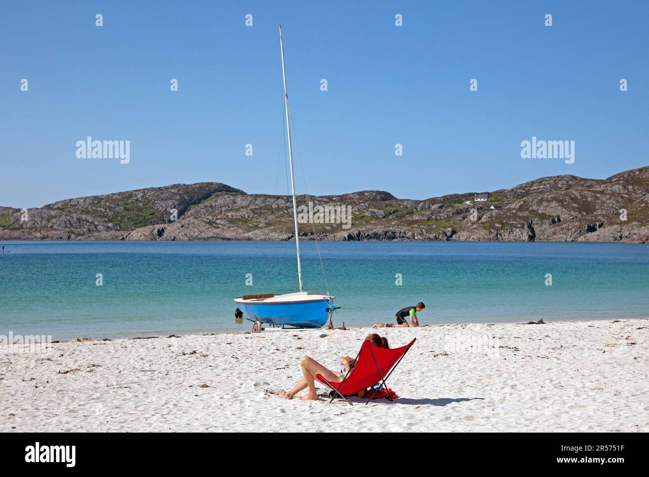 Achmelvich Bay, Assynt, Beach, Highlands, Scotland, UK. 1st June 2023. Sunny afternoon on the west coast of the Scottish Highlands temperature around 14 degrees centigrade. With scores of people out on the silver sand to take in the view of the award winning beach and watersports on The Minch. Stock Photo