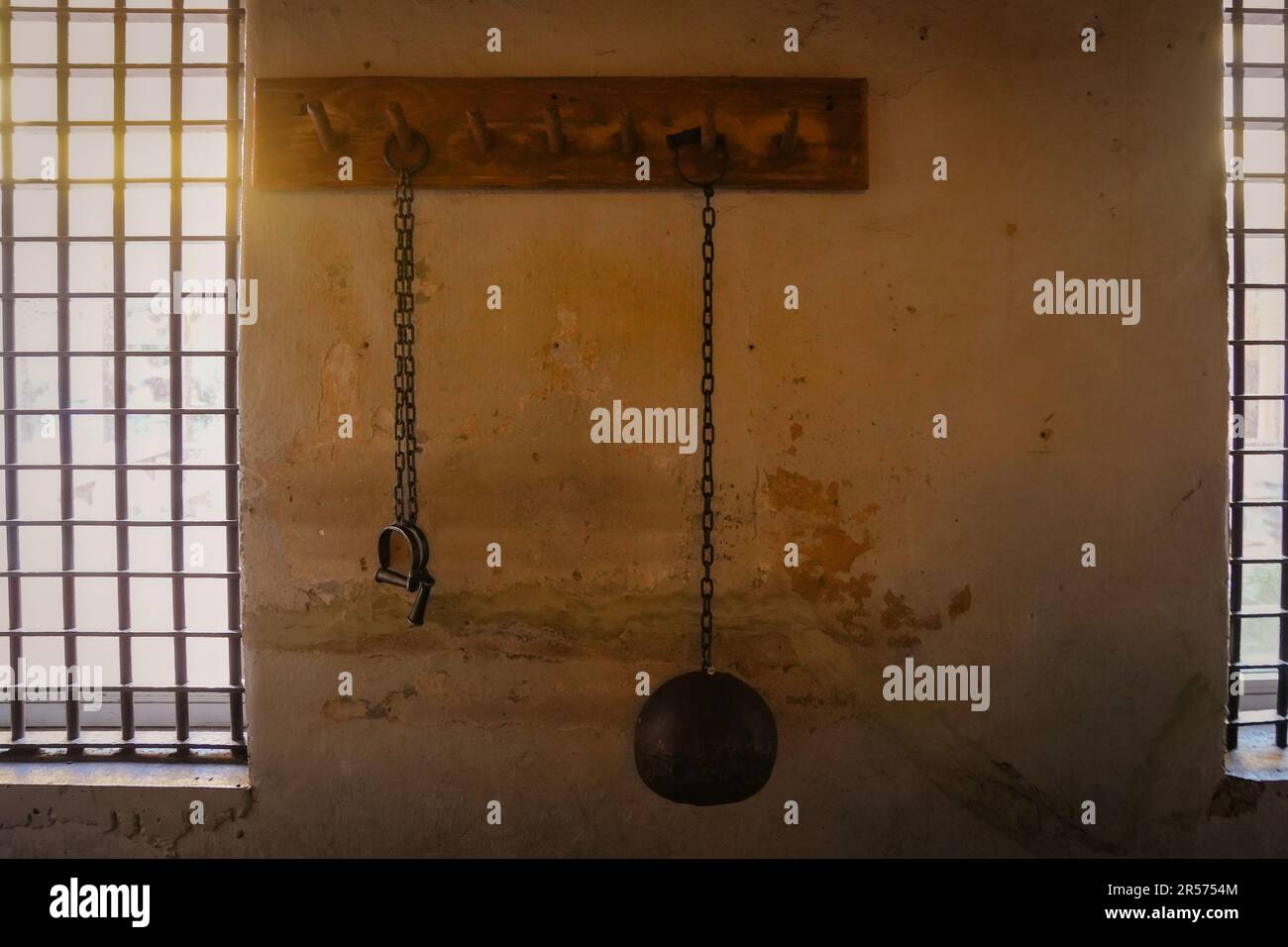 Ball and chain, and shackle hanging on a wall. Old jail in St. Augustine Florida Stock Photo