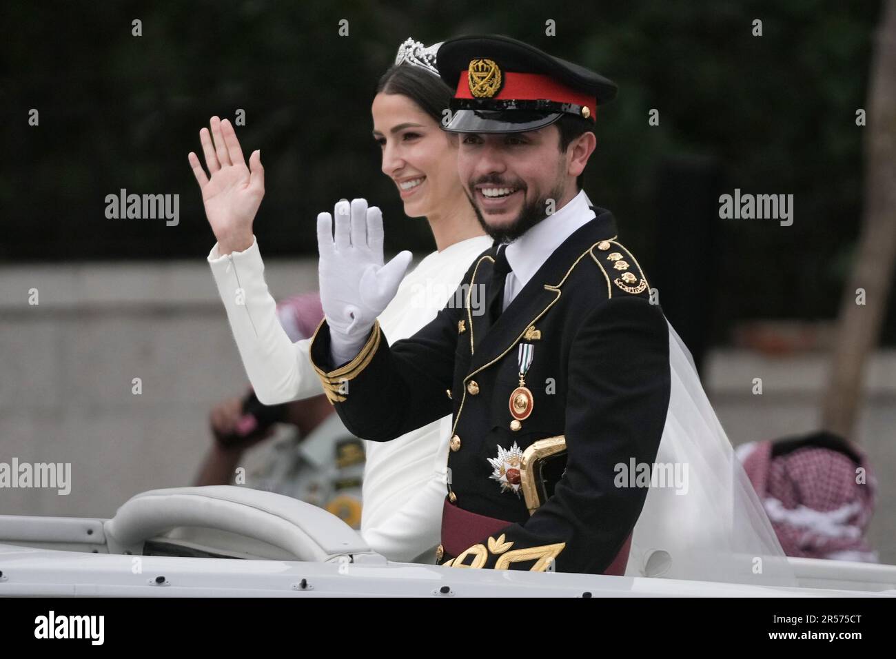 Jordan's Crown Prince Hussein and Saudi Rajwa Alseif wave to well