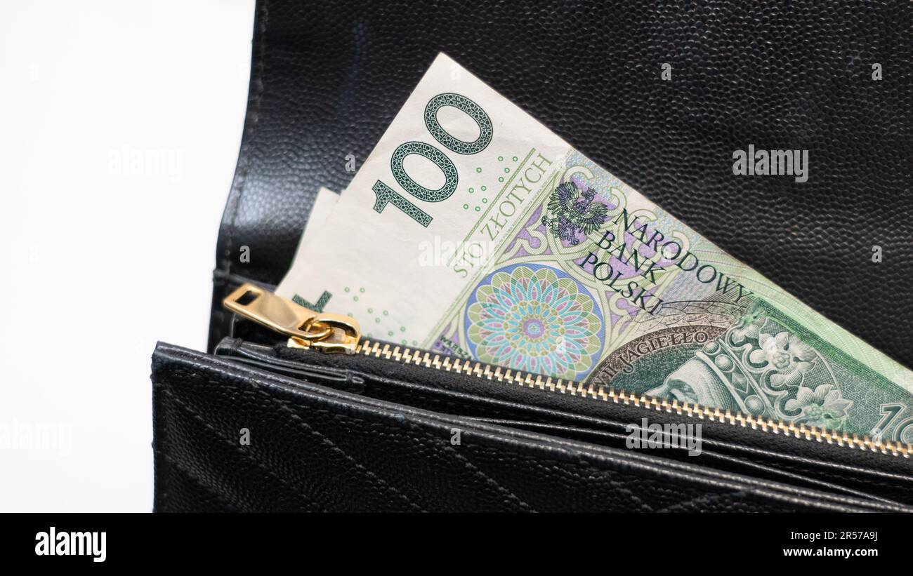 Polish money in a black wallet, holding money in a wallet, 100 polish note, Poland’s legal tender,, złotówki, polskie złote, PLN Stock Photo