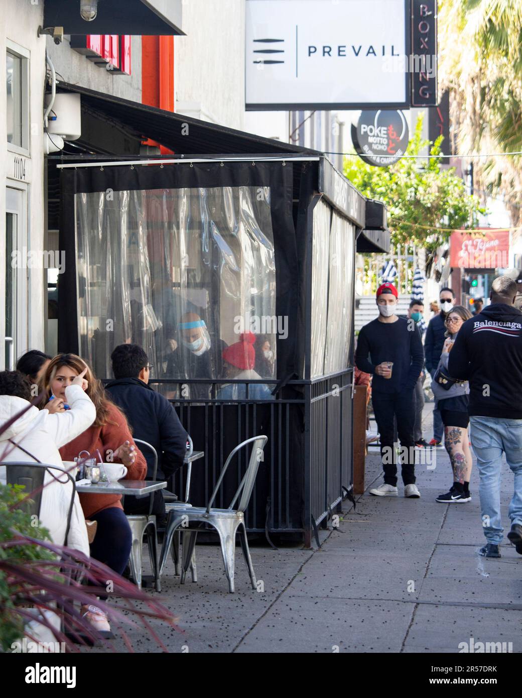 People dine outdoors in the North Hollywood Arts District in Los Angeles, Calif., on Saturday