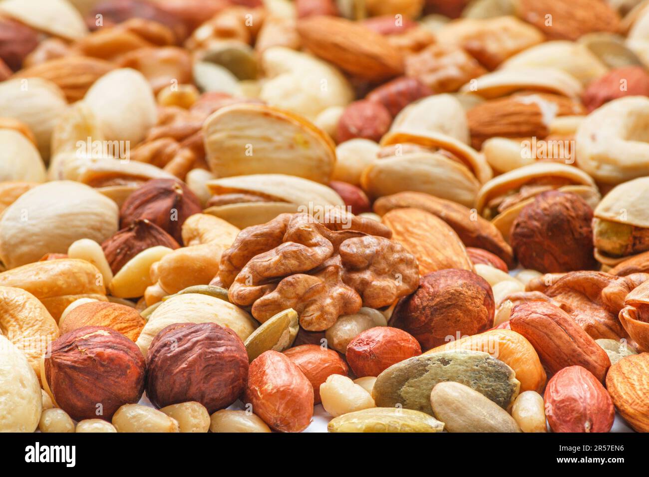 Different types of nuts and seeds, photo with selective focus. Peeled