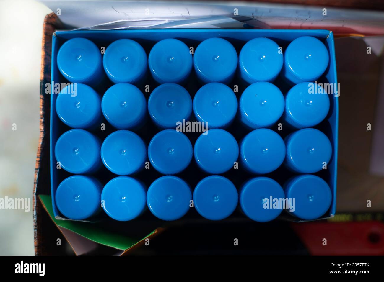 Glue in package. Many packs of glue. Blue Objects. Jars of substance