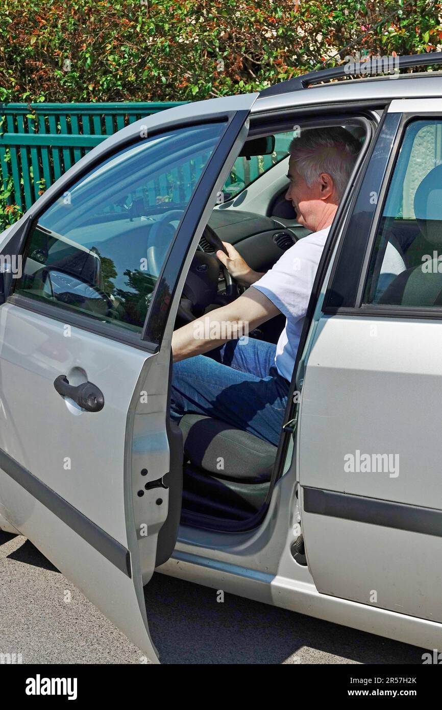 Man gets into a car, Germany Stock Photo Alamy