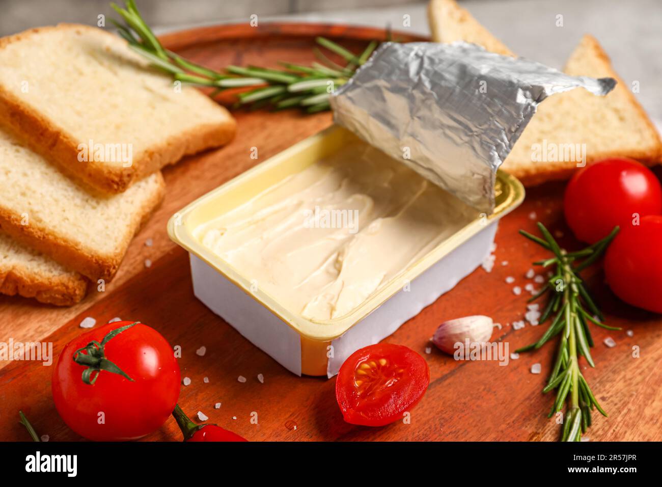 https://c8.alamy.com/comp/2R57JPR/plastic-container-with-tasty-cream-cheese-on-table-2R57JPR.jpg
