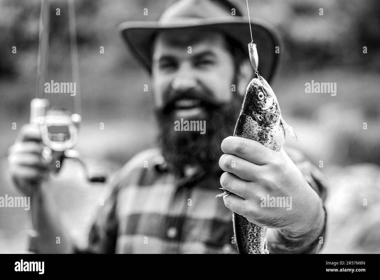 Fisherman holding fish Black and White Stock Photos & Images - Alamy