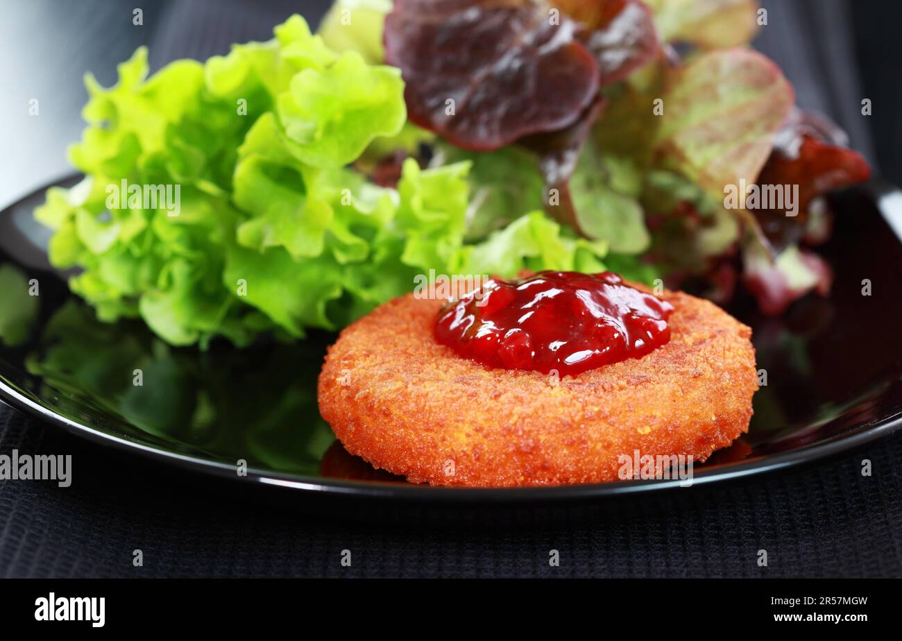 Baked Camembert with Cranberry Sauce and mixed salad Stock Photo