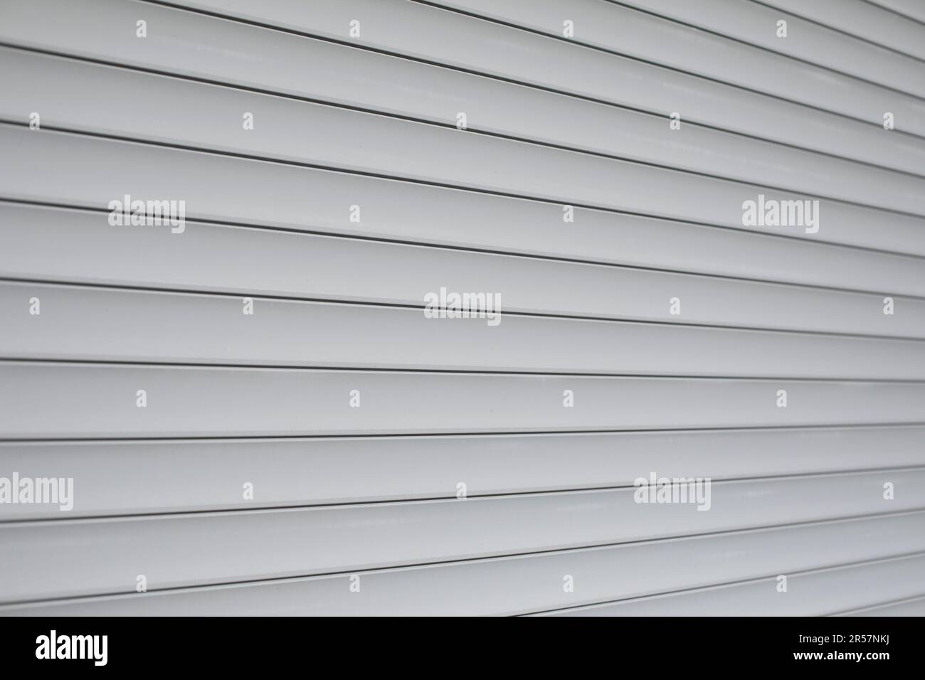Blinds on window. Plastic shutters. Ribbed surface. Closed windows. Stock Photo