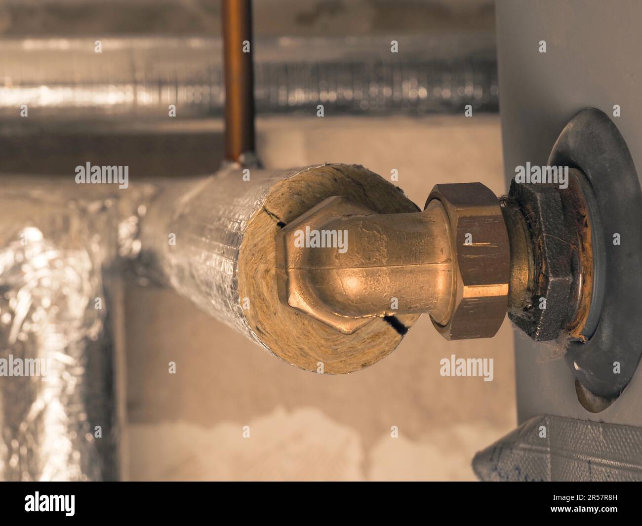 Heating pipes insulated with rock wool in a boiler room. Energy saving