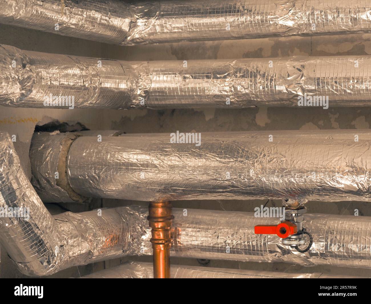 Heating pipes insulated with rock wool in a boiler room. Energy saving