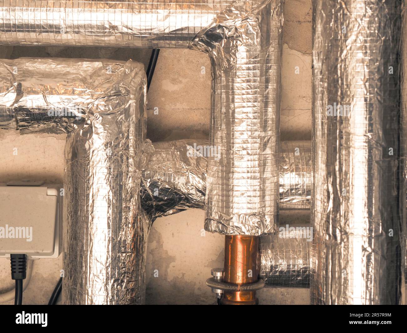 Heating pipes insulated with rock wool in a boiler room. Energy saving ...