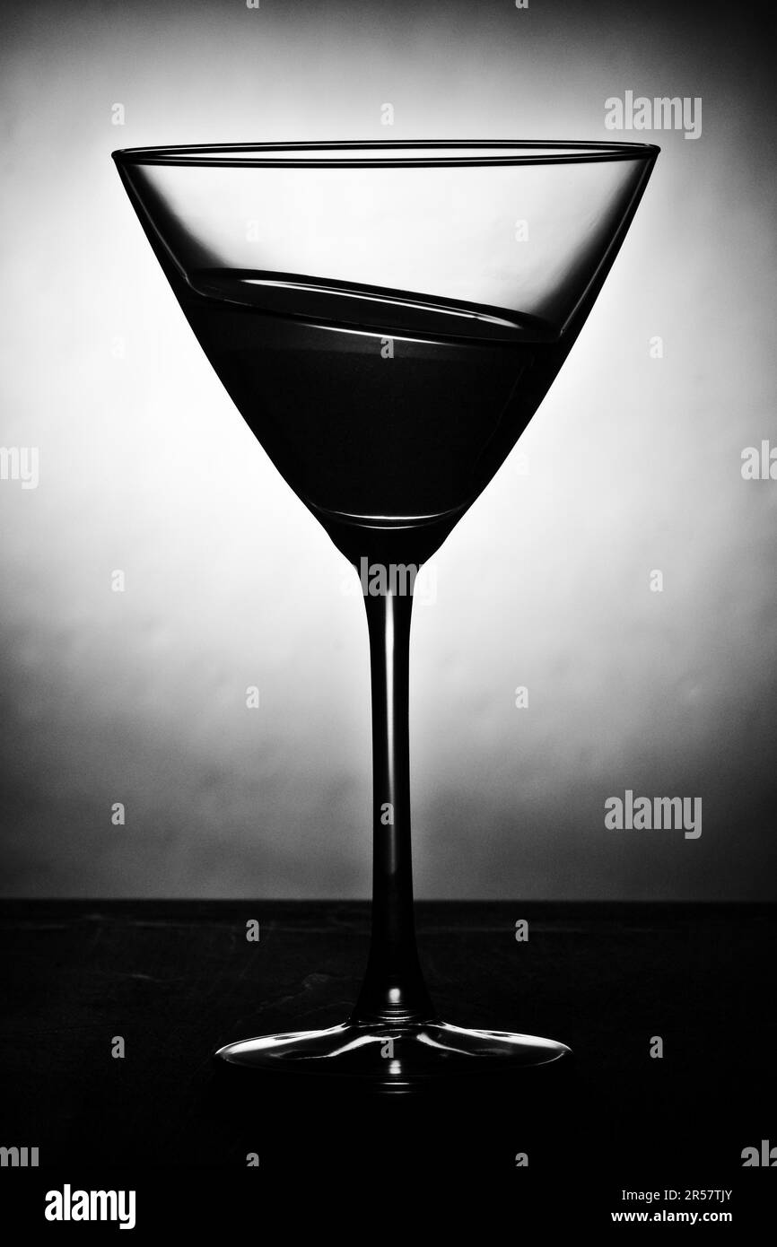 Cocktail glass filled with slate sloping liquid contrasting Stock Photo