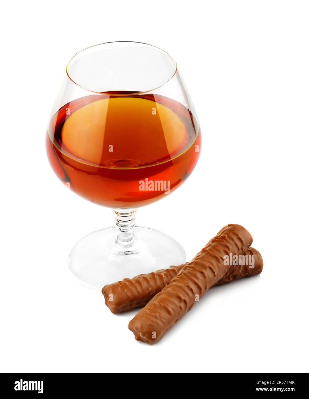 Glass with cognac and chocolate isolated on white background Stock Photo