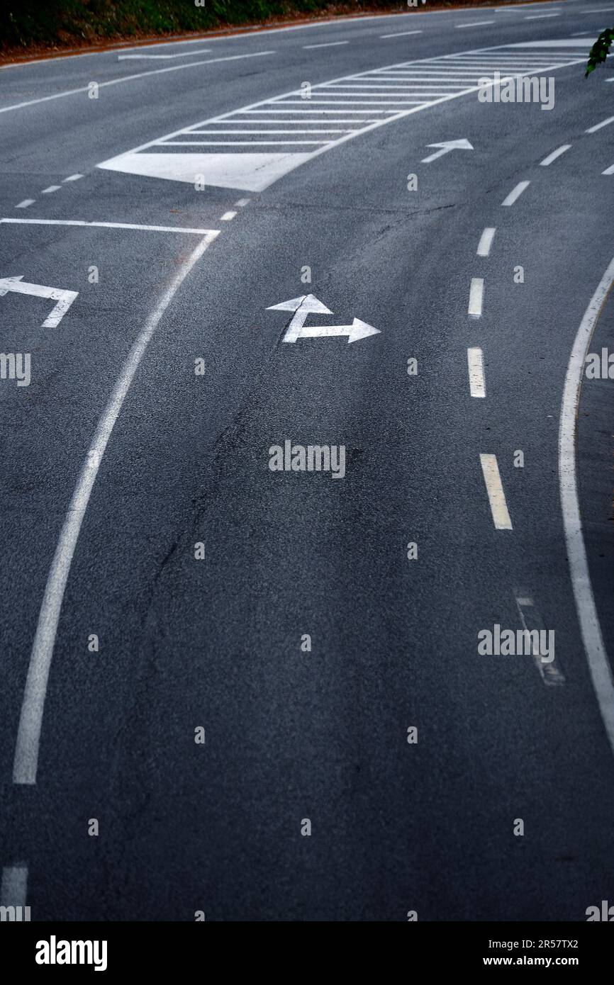 Road with turn direction lane marks Stock Photo