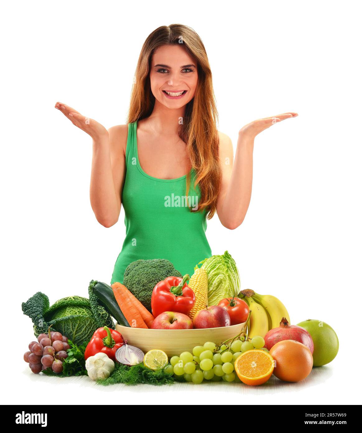 Young smiling woman with variety of fresh vegetables and fruits ...