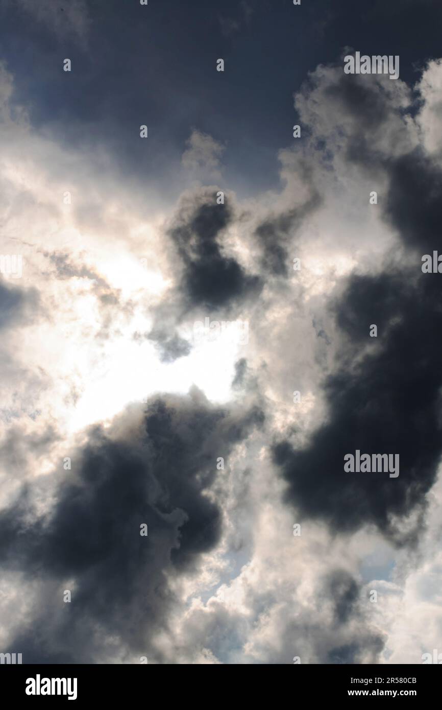 Dark stormy sky with clouds and sunlight, background Stock Photo - Alamy