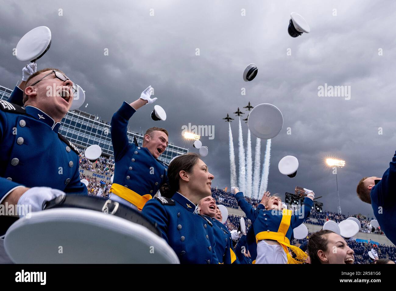 Graduates toss their hats at the conclusion of the 2023 United States