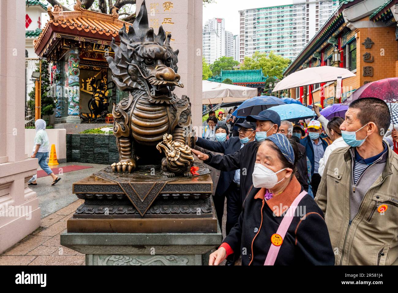 Chinese People Touching Statues For Good Luck At The Wong Tai Sin