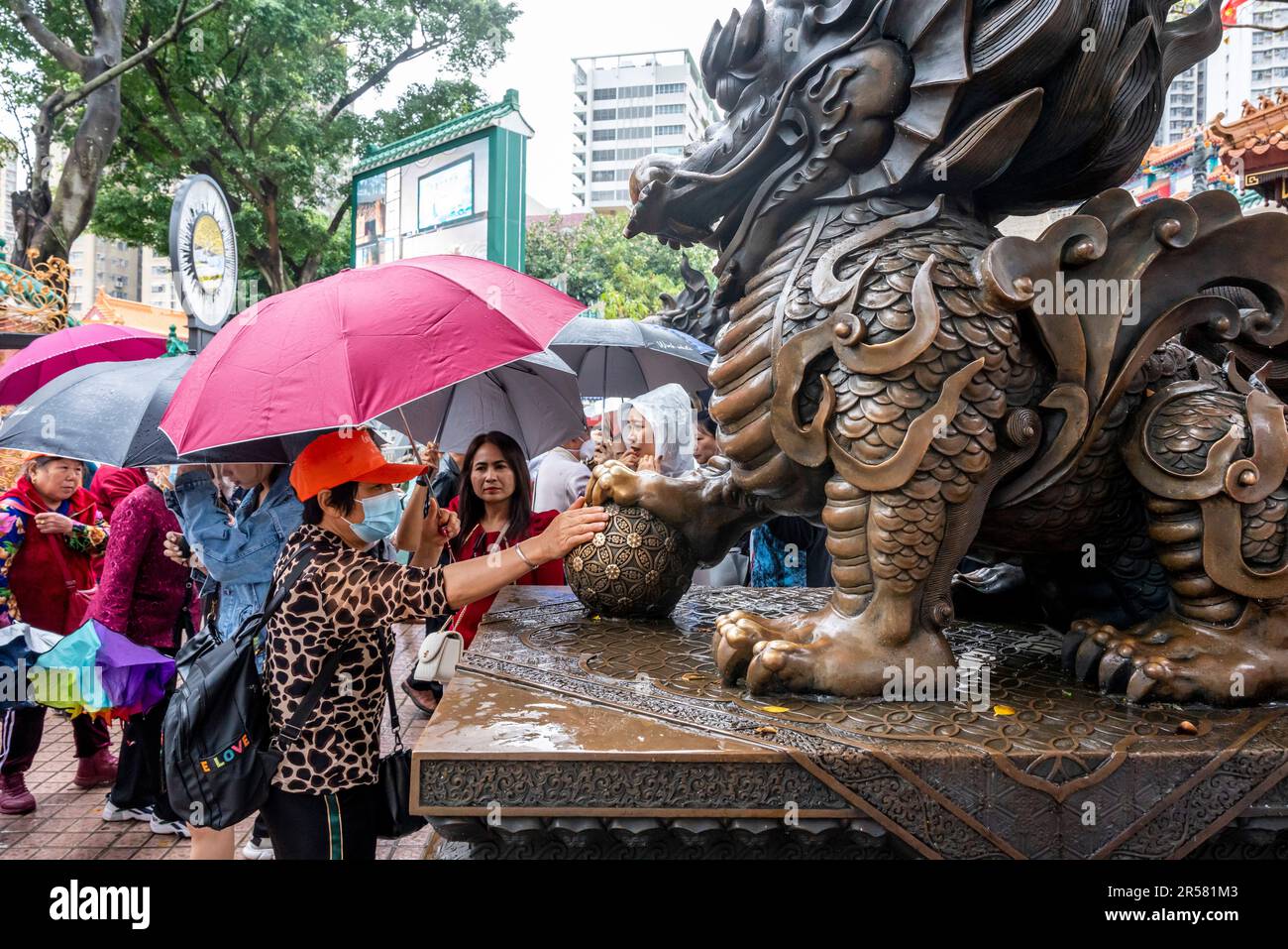 Chinese People Touching Statues For Good Luck At The Wong Tai Sin
