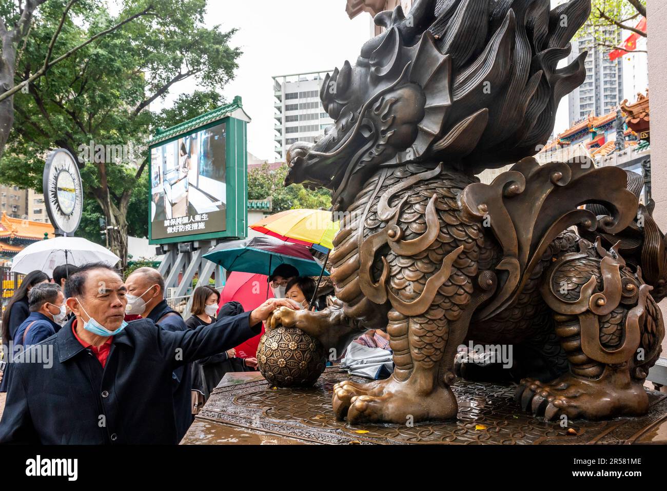 Chinese People Touching Statues For Good Luck At The Wong Tai Sin