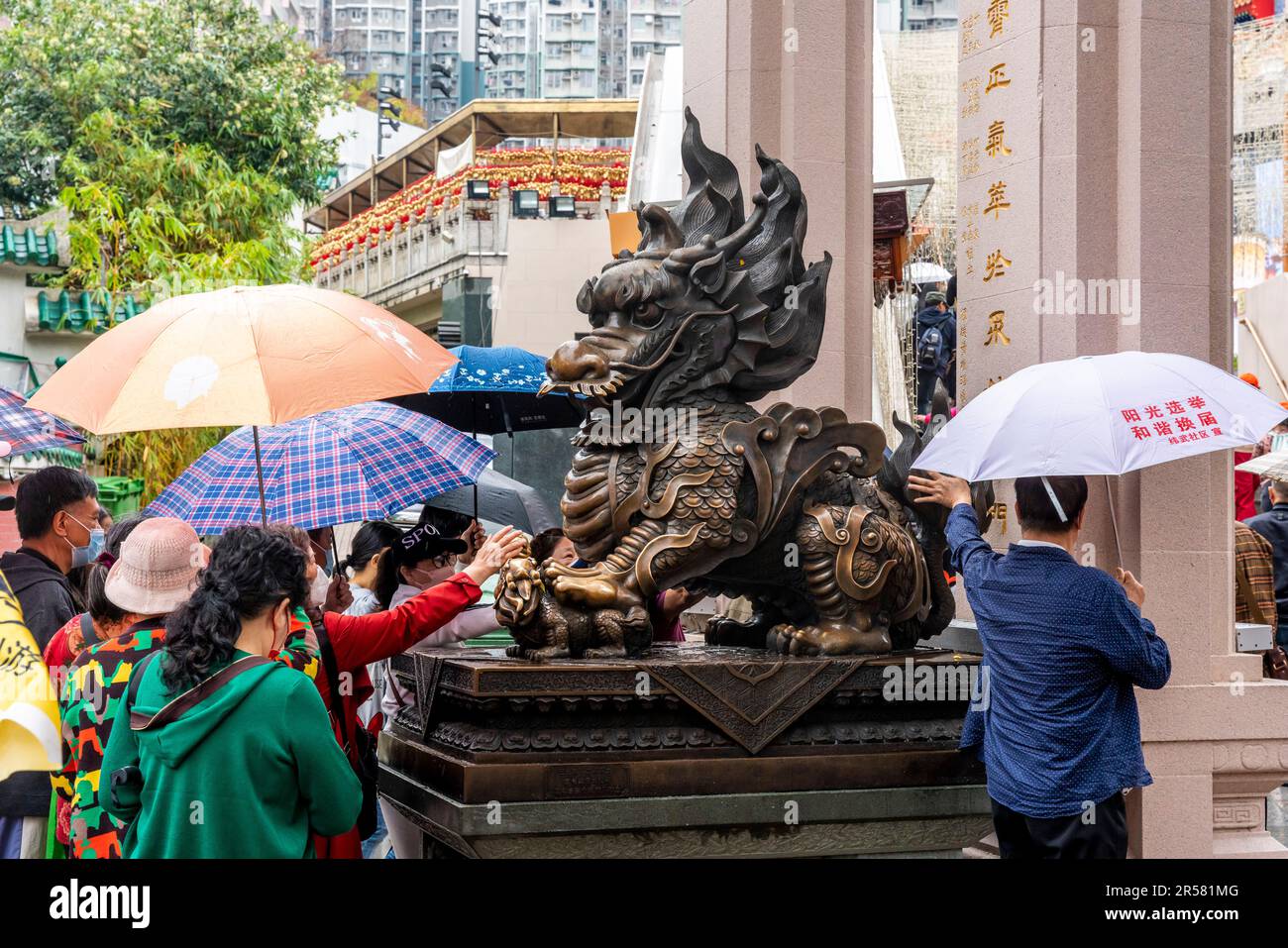 Chinese People Touching Statues For Good Luck At The Wong Tai Sin