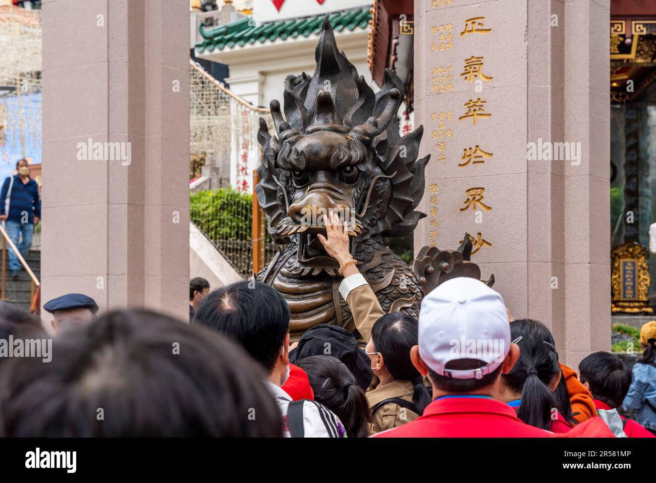 Chinese People Touching Statues For Good Luck At The Wong Tai Sin