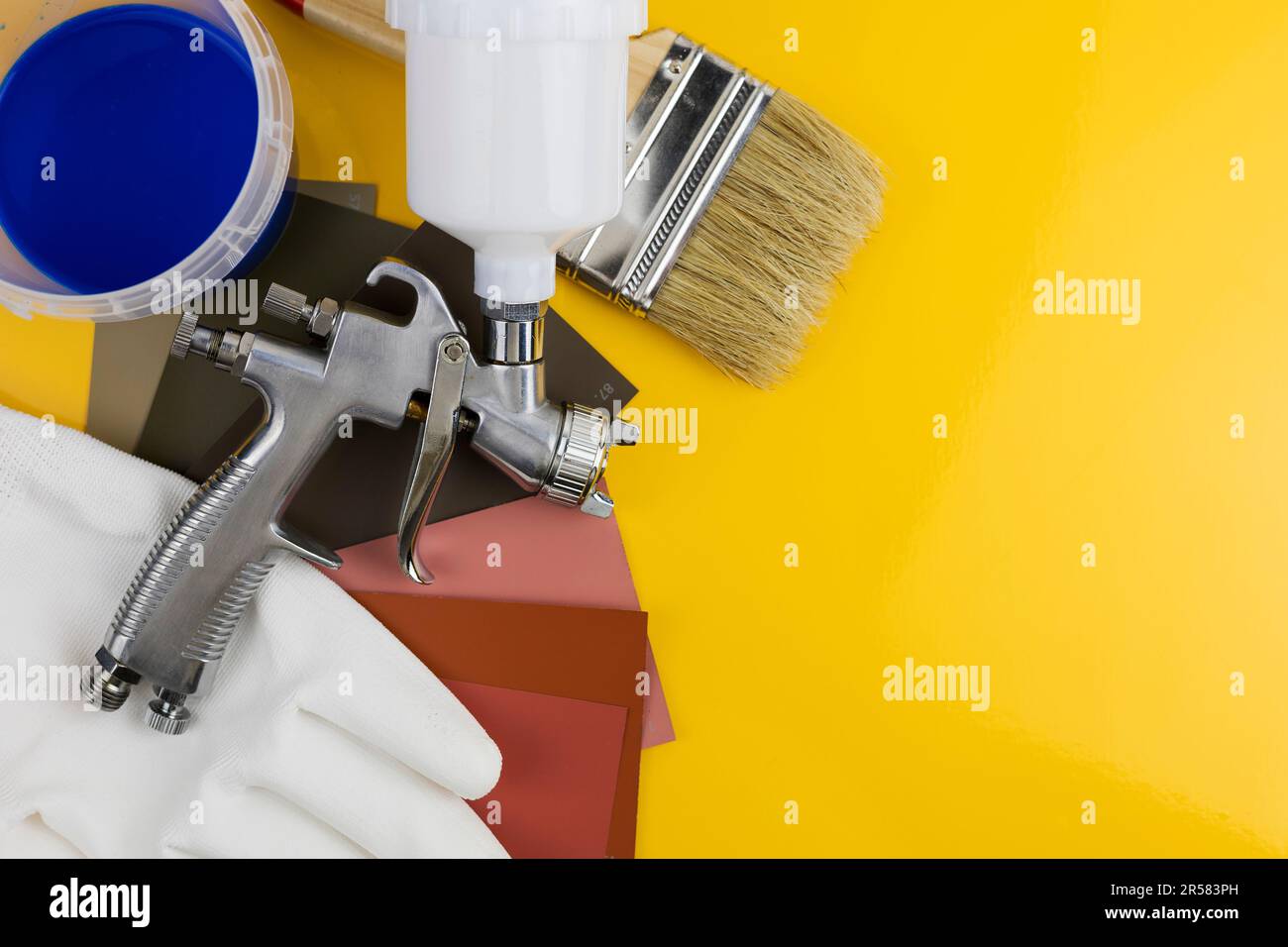 Paint spray gun at work at the workplace in the Paint Brush