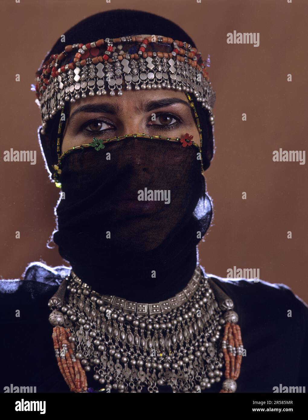 Young woman with face veil and antique silver jewellery, Sanaa, Yemen Stock Photo
