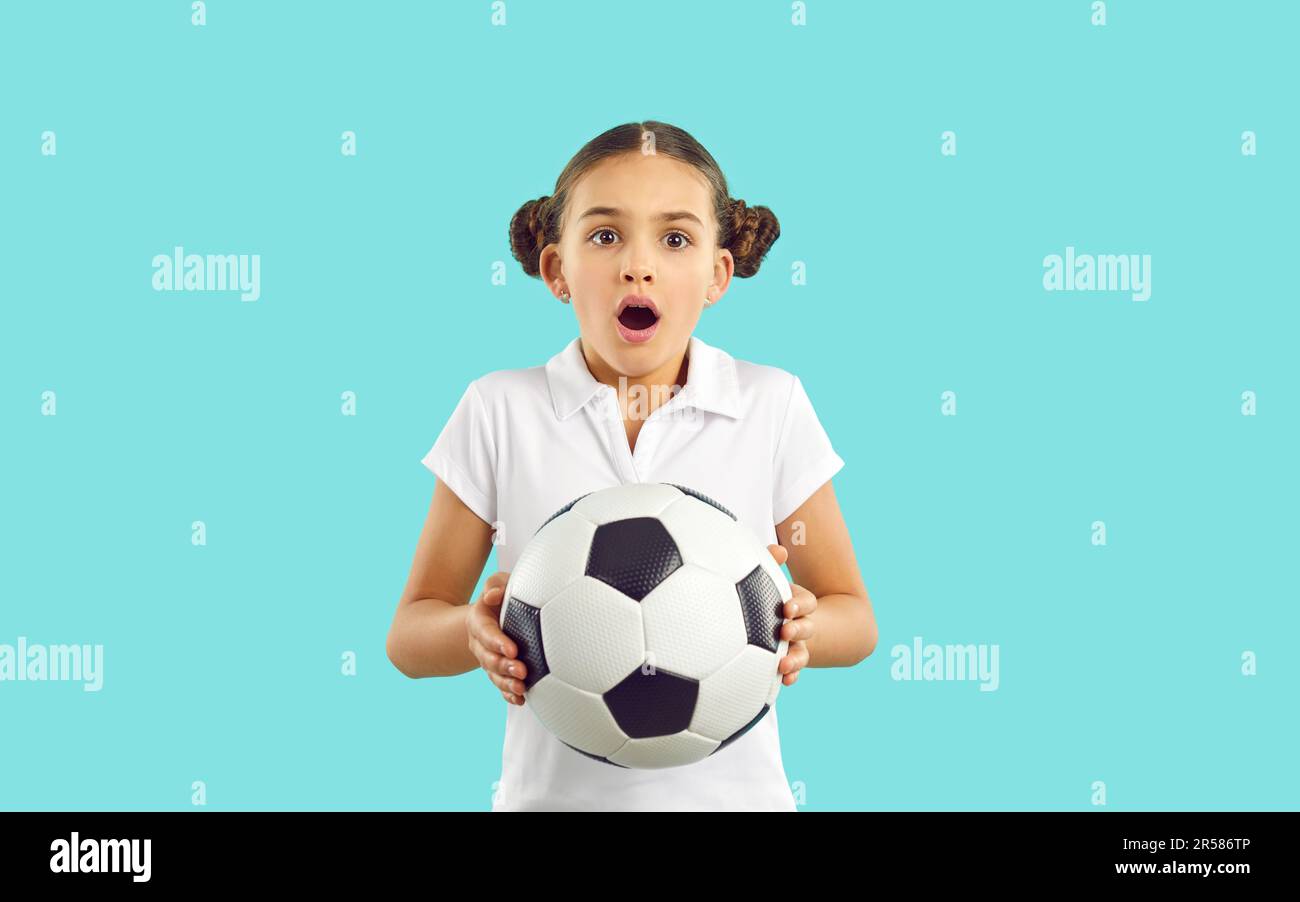 Amazed teen girl child hold football ball Stock Photo