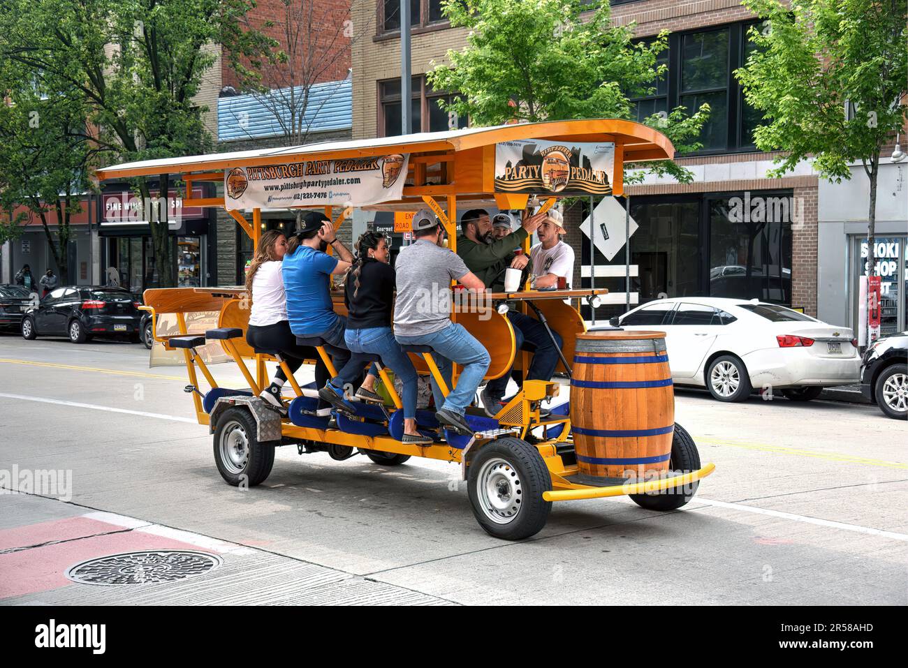 Pittsburgh, PA, USA- May 20, 2023: A crowd enjoys the ride on the Pittsburgh Party Pedaler on Liberty Avenue. These vehicles are powered by the pedali Stock Photo