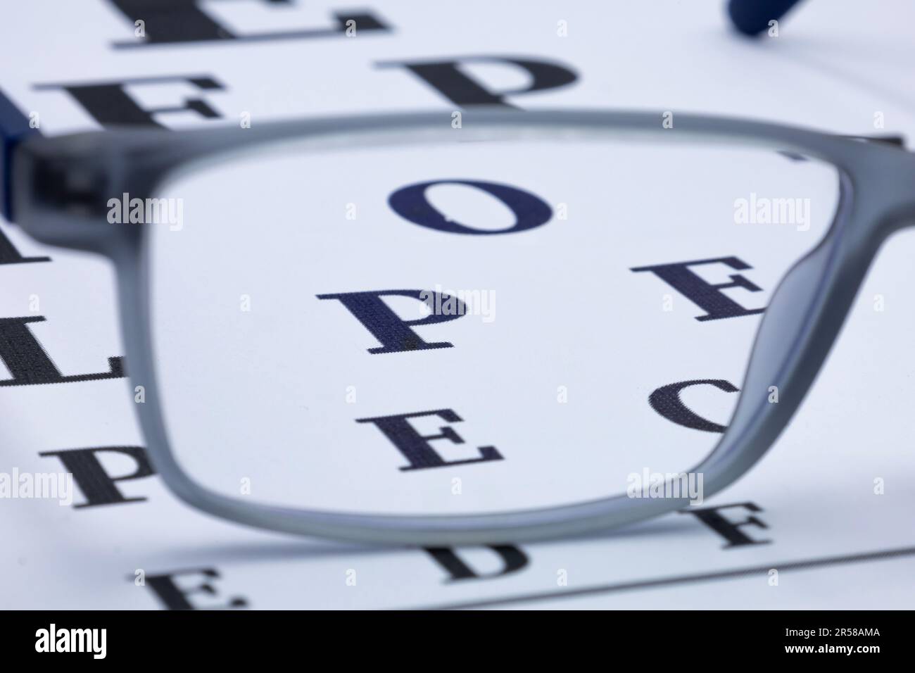 Eye glasses on eyesight test chart background close up Stock Photo