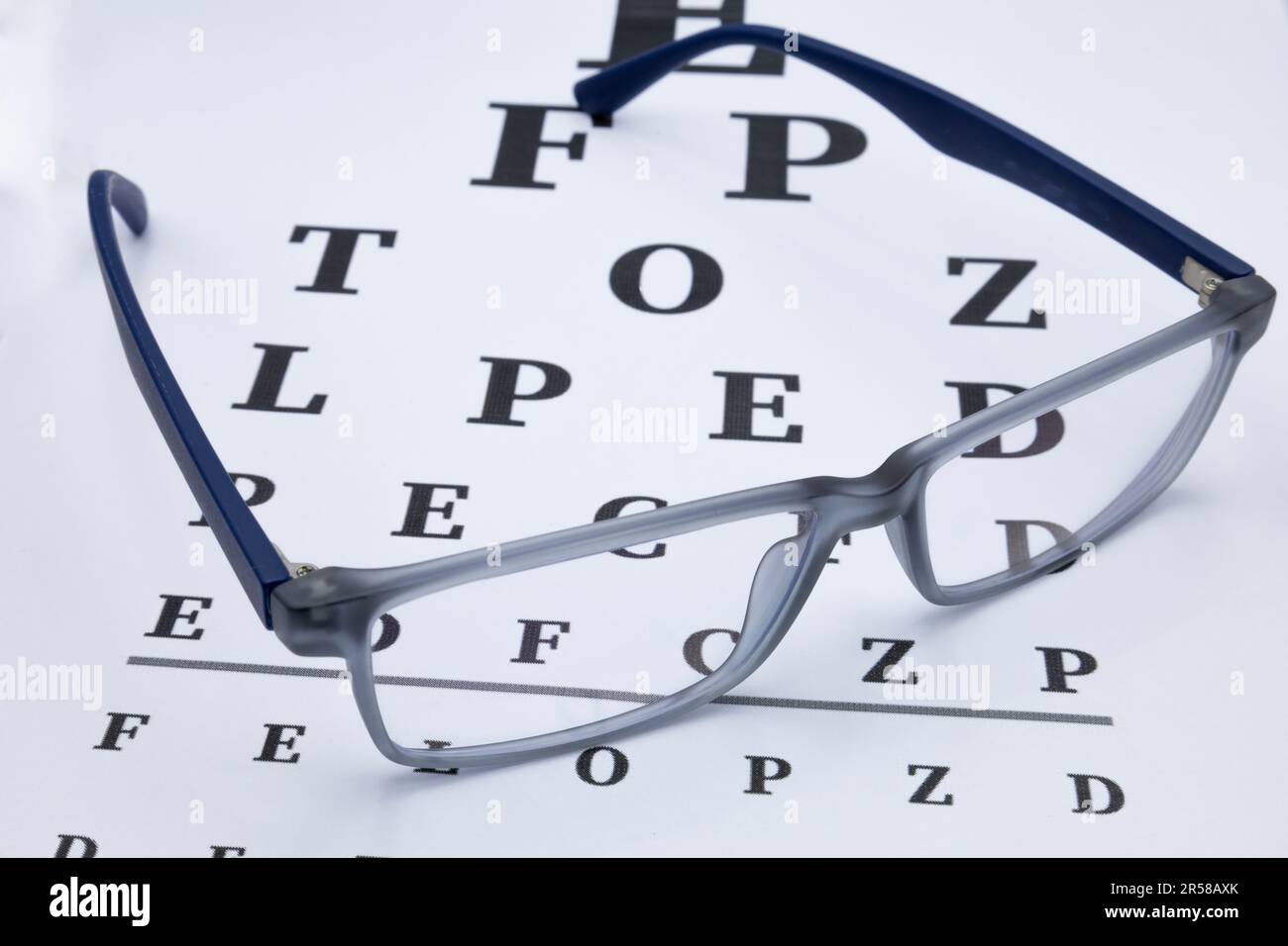 Dark blue glasses on a eyesight test chart Stock Photo