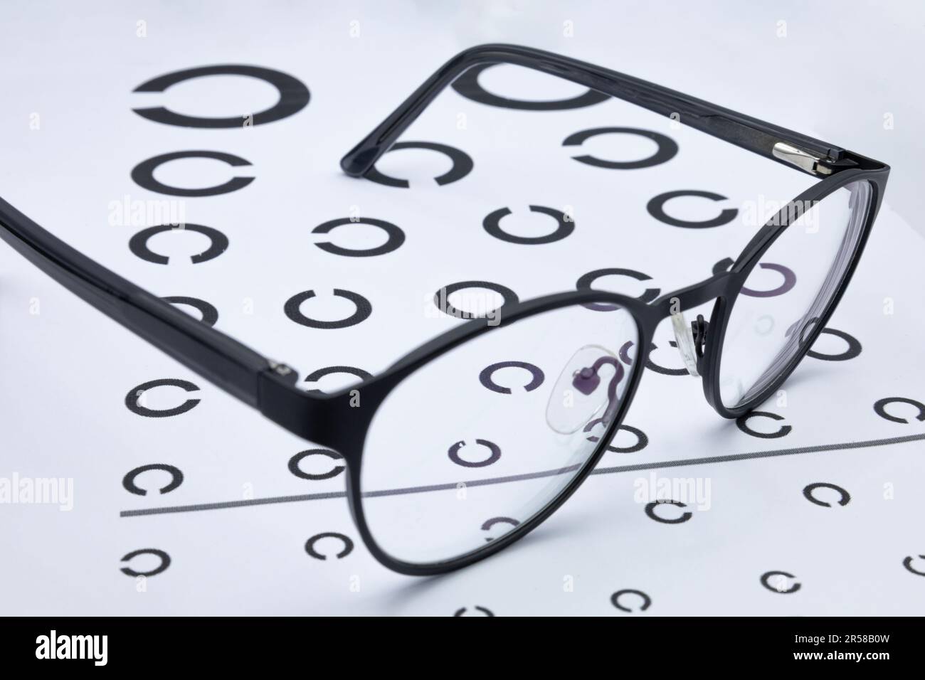 Black glasses on a eyesight test chart Stock Photo