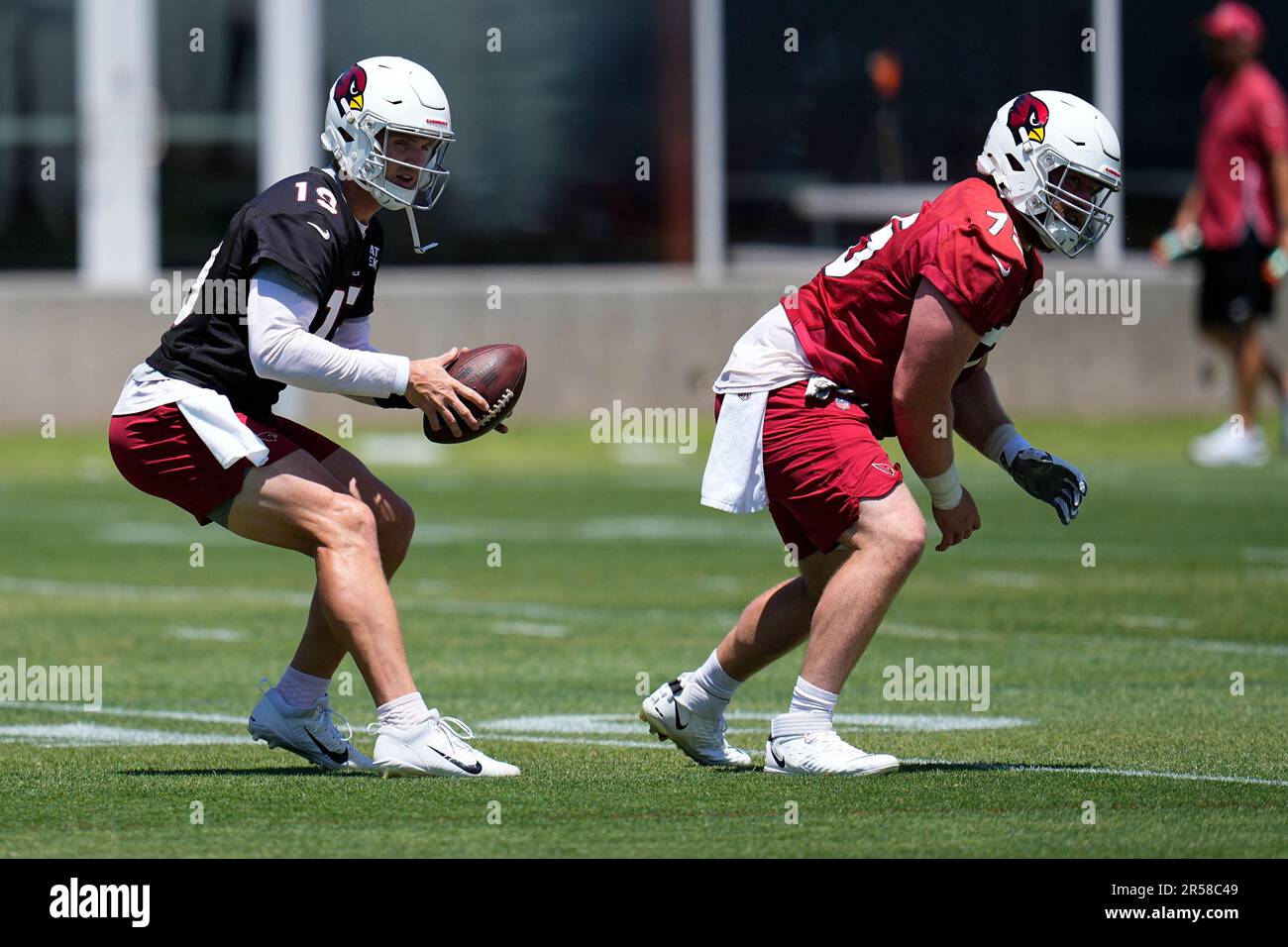 Arizona Cardinals wide receiver Rondale Moore (4) flips the ball to  quarterback Jeff Driskel (19) during NFL football practice at the team's  training facility, Tuesday, June 13, 2023, in Tempe, Ariz. (AP