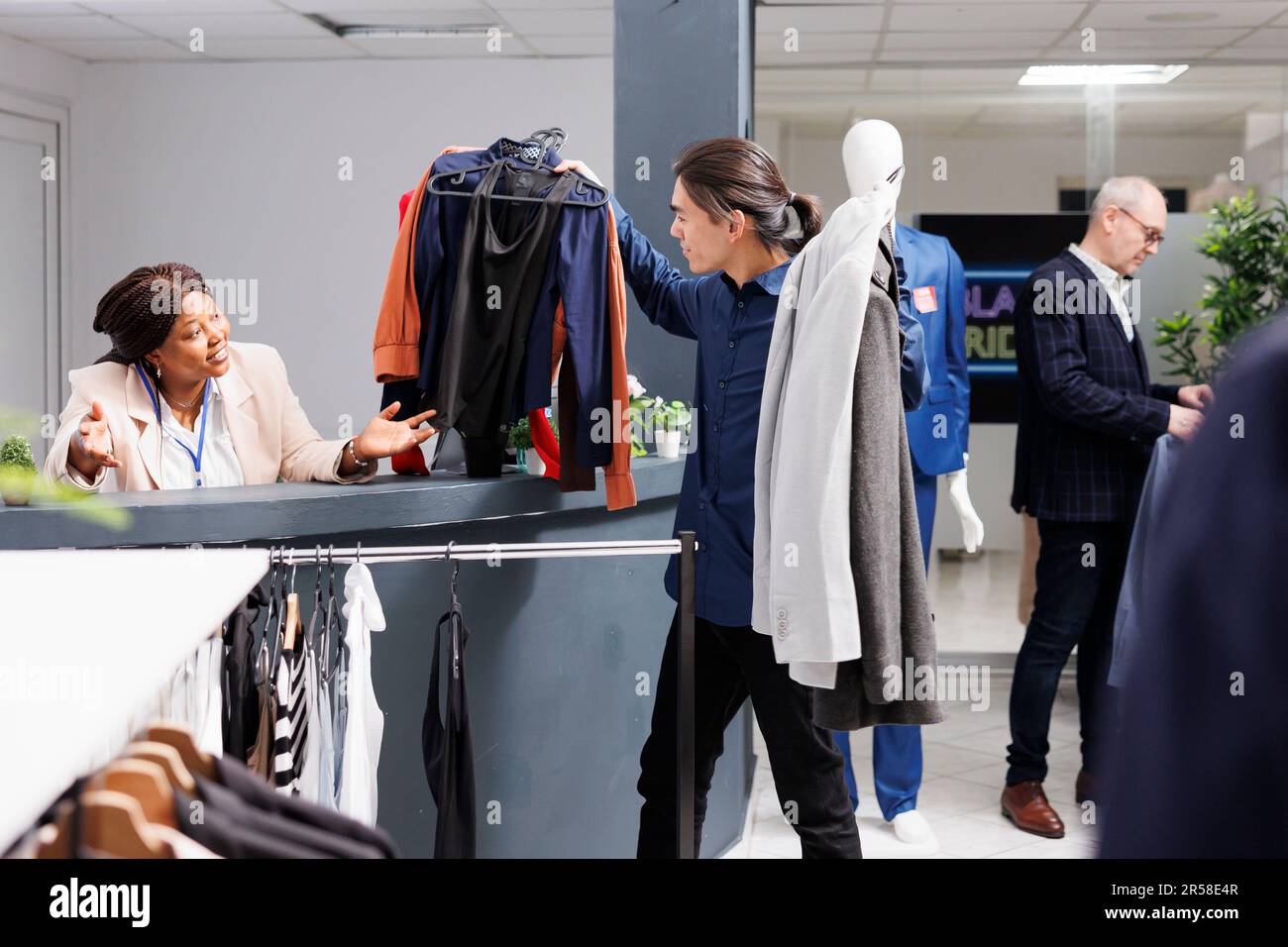Customer putting clothes on fashion store counter desk talking with