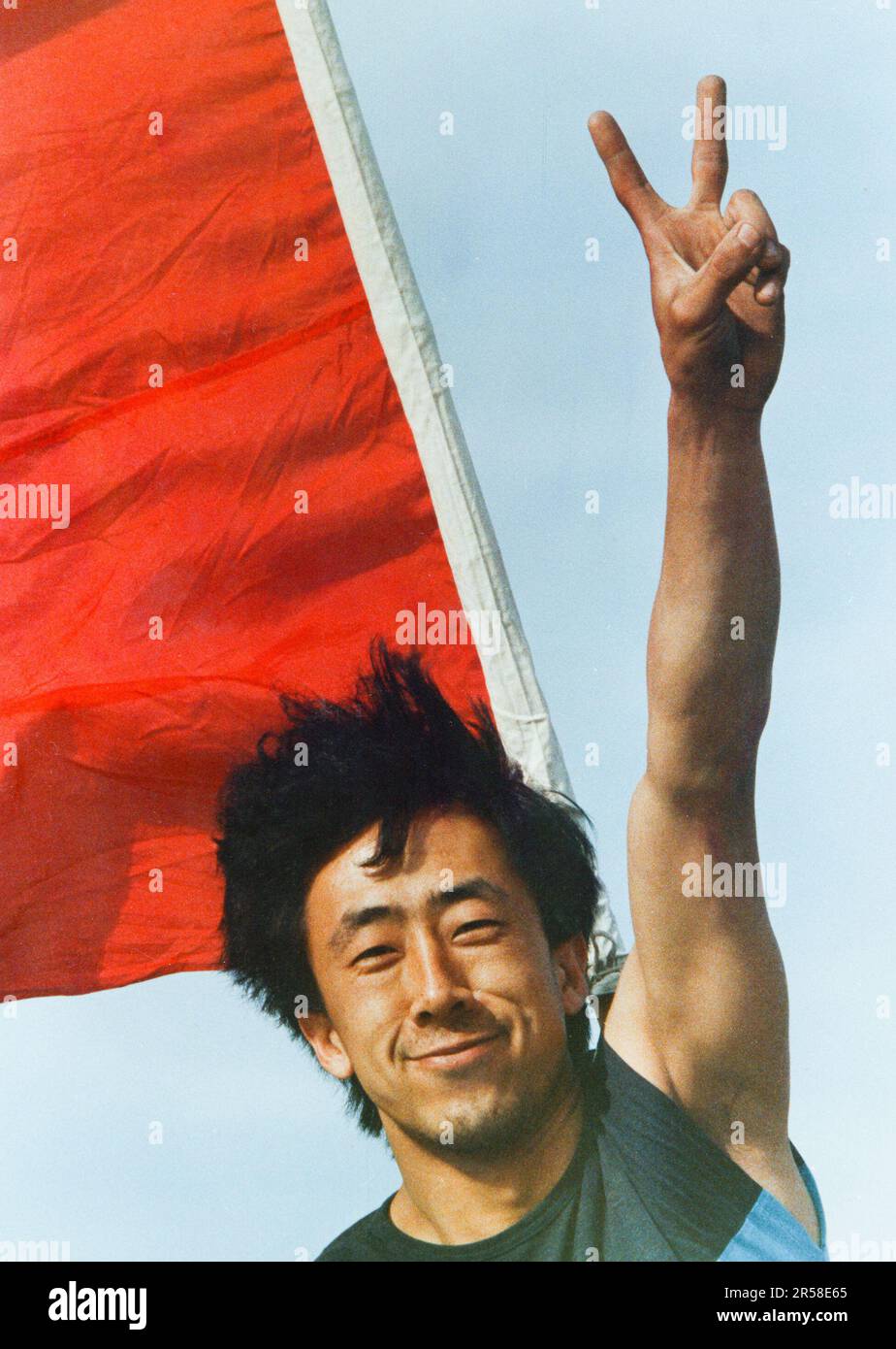 A Chinese pro-democracy protester flashing a 'v' for victory sign on May 20, 1989, the beginning of the second week of a mass popular uprising in Beijing supporting students in Tiananmen Square seeking government reform. Stock Photo