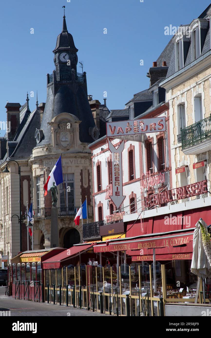 The town hall - Hotel de Ville - cafes and restaurants lining the bank of the  Touques River Trouville-sur-Mer Normandy France Stock Photo