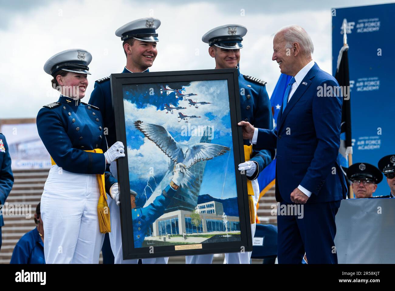 Colorado Springs, United States of America. 01 June, 2023. U.S President Joe Biden accepts a gift of a painting from the Class of 2023 cadets during the commencement ceremony for the United States Air Force Academy graduation at Falcon Stadium, June 1, 2023 in Colorado Springs, Colorado. Credit: Trevor Cokley/U.S. Air Force Photo/Alamy Live News Stock Photo