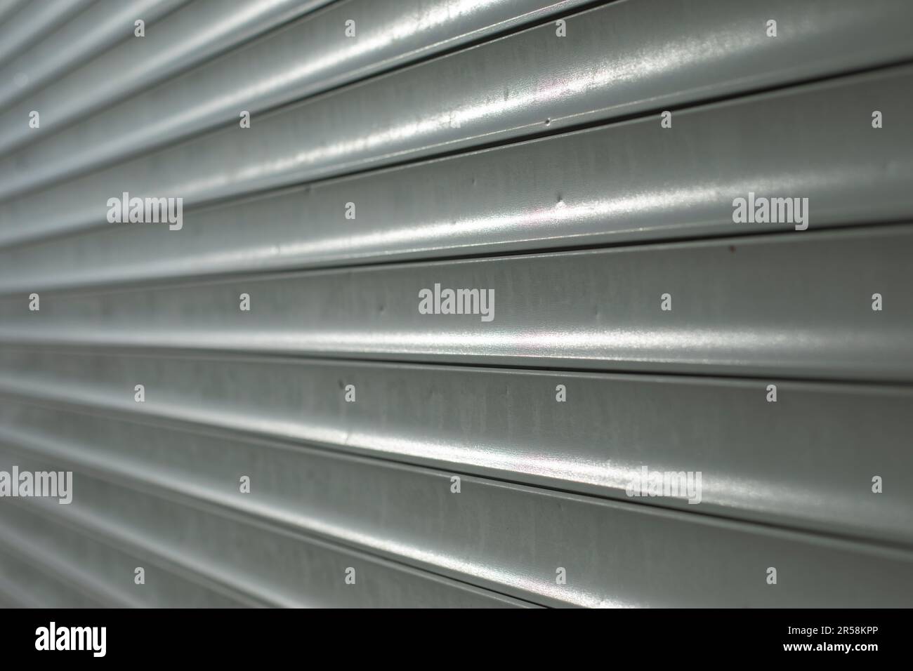 Blinds on window. Plastic shutters. Ribbed surface. Closed windows