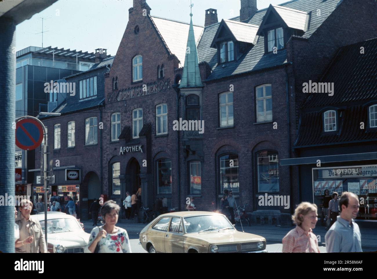 Roskilde, Demark, September 1973- Vintage pharmacy building at 52 Algade, Dom Apothek, 1970s pedestrians Stock Photo